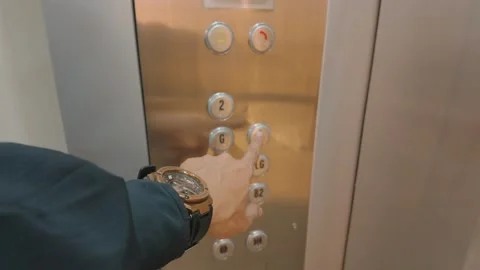 Close up of a man pushing a button inside a modern elevator. Stock Footage 343419487