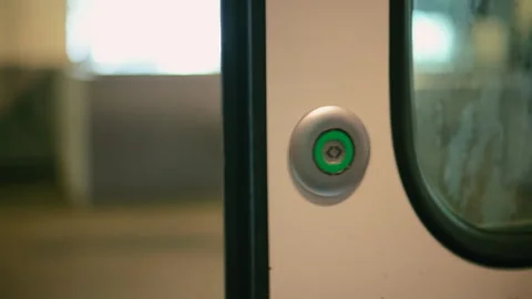 Close up of a man pushing a button to open the doors and people getting out of a Stock Footage 306021789