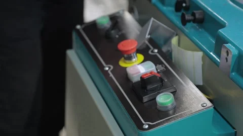 Close-up of man pushing buttons on sawing machine in workshop Stock Footage 302473386