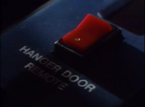 Close-up of man pushing hanger door remote button,1980s Stock Footage 260240360