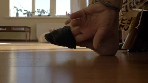 Close-up man puts on a black sock. 4k video. slow motions. 23.98 fps Stock Footage 118137700