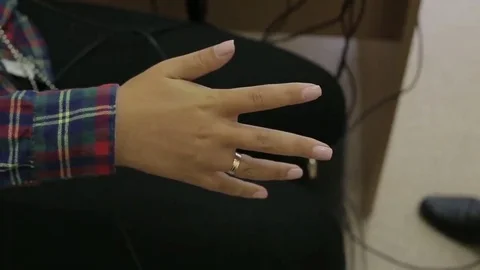 Close up A man puts a female hands on the sensors lie detector test Stock Footage 69321913