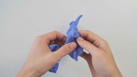 Close-up, a man puts on his hands blue medical, latex gloves. The view from the Stock Footage 121761832