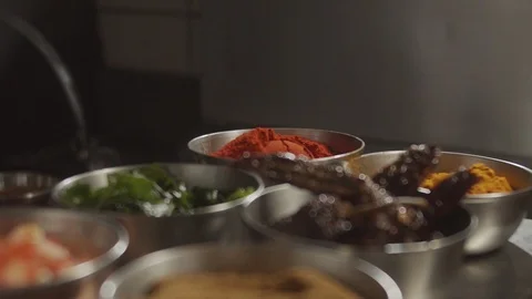 Close-up man puts spoon in bowl with red spices. Red pepper, paprika. Slow Stock Footage 124735672
