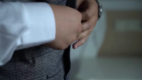 Close up, man puts on a vest, jacket Video stock 125253160