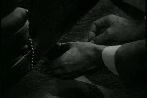 Close-up man putting bomb under door Stock Footage 11347189