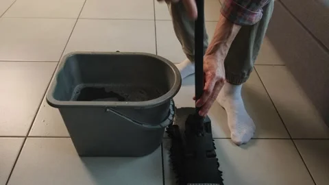Close up of man putting cloth on mop. Illustrating inconvenient mop design and Stock Footage 316060304
