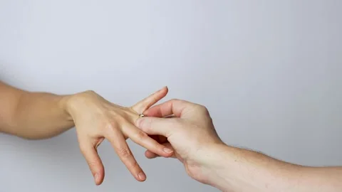 Close-up of a man putting the diamond ring on woman hand Stock-Footage 261563153