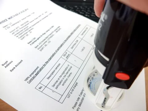 Close-up of a man putting a stamp on a document. Business concept Stock Photos