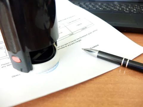 Close-up of a man putting a stamp on a document. Business concept Stock Photos