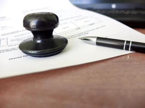 Close-up of a man putting a stamp on a document. Business concept Stock Photos