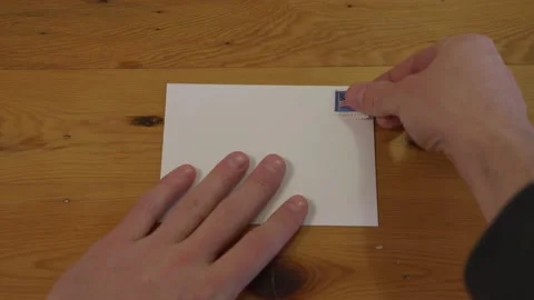 Close Up of a Man Putting a Stamp on an Envelope Stock Footage 148342981