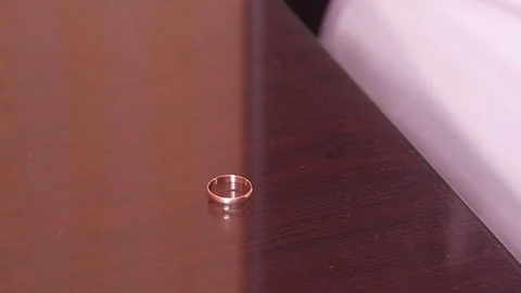Close-Up. Man putting Off Wedding Ring and take It On Table Stock Footage 283847353