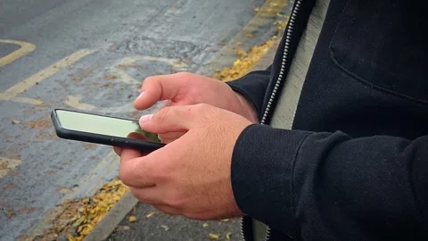 Close up man quickly scrolling through news feed on social networks phone at bus Stock Footage 303497689