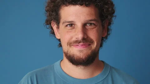 Close-up, man raising his head and looking at the camera with smile isolated on Stock Footage 249732263