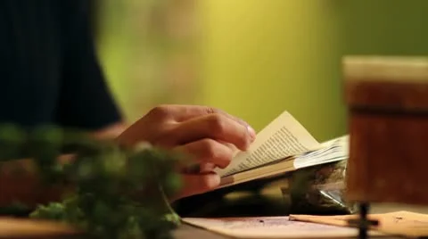 Close up of a man reading a book about herbs and hops Stock Footage 27851236