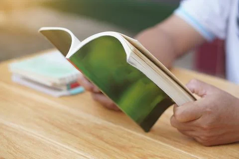 Close up man is reading book. Stock Photos