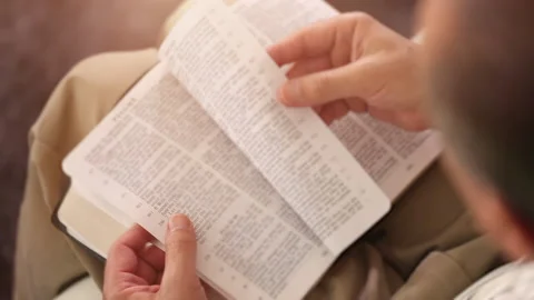 Close Up of a Man Reading the Holy Bible Stock Footage