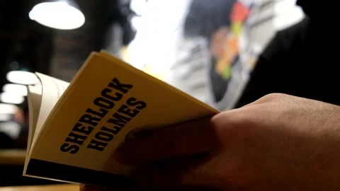 Close up of a man reading sherlock holmes book, Stock Footage 167740224