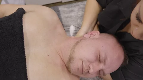Close up of a man receiving a neck and shoulder massage Stock Footage 331460925