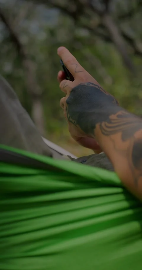 Close-Up Of Man Relaxing In A Green Hammock Outdoors... Stock Footage 331820841