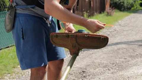 Close Up Of A Man Replacing The String In A Weed Trimmer. Slow Motion. Stock Footage 112872911