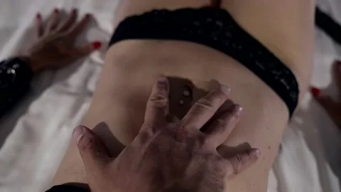 Close-up of a man with a rough hand caressing the tender tummy of his beloved Stock-Footage 223496364