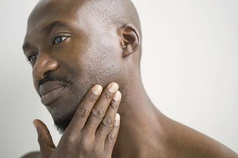 Close up of man rubbing stubble on face Stock Photos