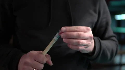 Close-up of a man rubs the tip of a billiard cue with chalk before hitting Stock Footage 146809553