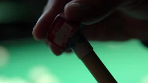 Close-up of a man rubs the tip of a billiard cue with chalk before hitting Video stock 146809799