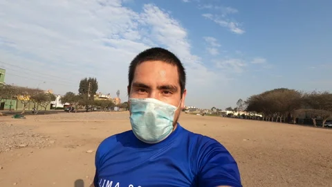 Close up of a man running with his mask looking at the camera 動画素材 141662263