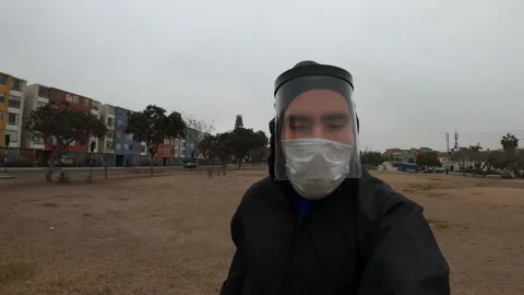 Close-up of a man running with a mask, face shield and romper 库存影片 141656680