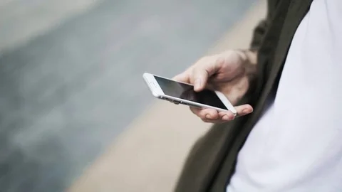 Close up of man s hand with a smartphone swiping and zooming in 스톡 동영상 77488699