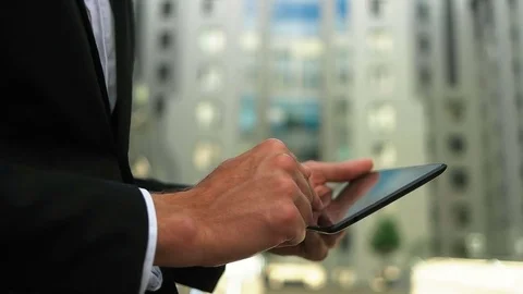 Close up of man s hands using tablet in the street, outdoors portrait Stock Footage 73812932