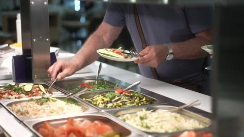 Close up of man selecting food from a buffet counter Stock Footage 295139598