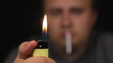 Close-up, man sets a gas lighter on fire. Focus on the lighter. 스톡 동영상 95067713