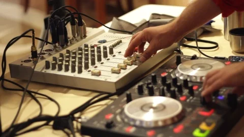 Close-up of man setting up a DJ controller and checking a sound. Stock footage Video stock 122089689