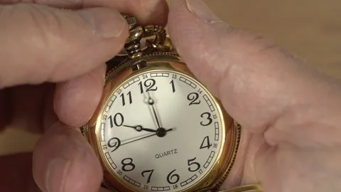 Close up of a man setting a pocket watch Stock Footage 232806716