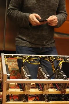 Close-up of a man setup or maintaining a cryptocurrency mining rig with gra.. Stock Photos