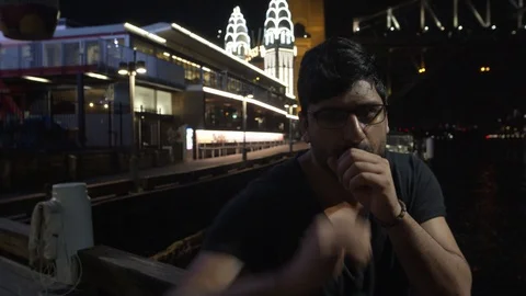 Close Up Man Shadow Boxing at Camera on Wharf Near Sydney Harbour Bridge, Night Stock Footage 107901427