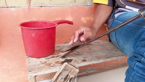 Close up of a man sharpening a traditional machete with a whetstone Stock Footage 335019728