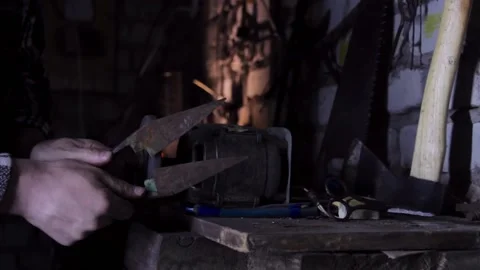 Close-up of a man sharpens a sicator on a grinder sharpener Stock Footage 135654955