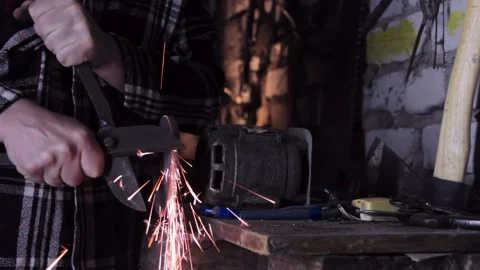 Close-up of a man sharpens a sicator on a grinder sharpener Stock Footage 137970721