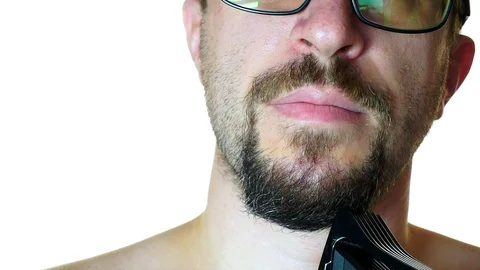 Close-up of a man shaves his beard trimmer machine 스톡 동영상 100453529