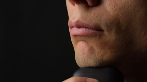 Close up man shaving face with compact electric shaver, personal grooming and Stock-Footage 317846907
