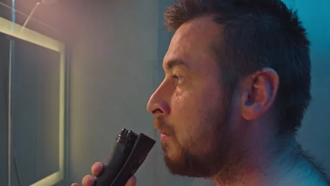 Close-up of a man shaving his beard with a trimmer. Stock Footage 288497884