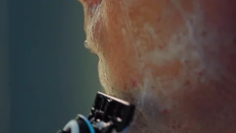 Close-up of a man shaving with a razor in the bathroom. Stock Footage 288632168