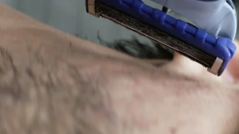 Close-up man shaving razor face beard. First-person view, camera follows razor Stock Footage 132082989