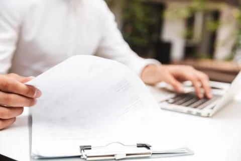 Close up of a man in shirt working with documents Stock Photos