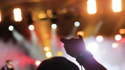 Close up: man showing devil horns gesture at rock concert in front of stage Stock Footage 195735490